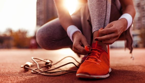 Runner putting on running shoes